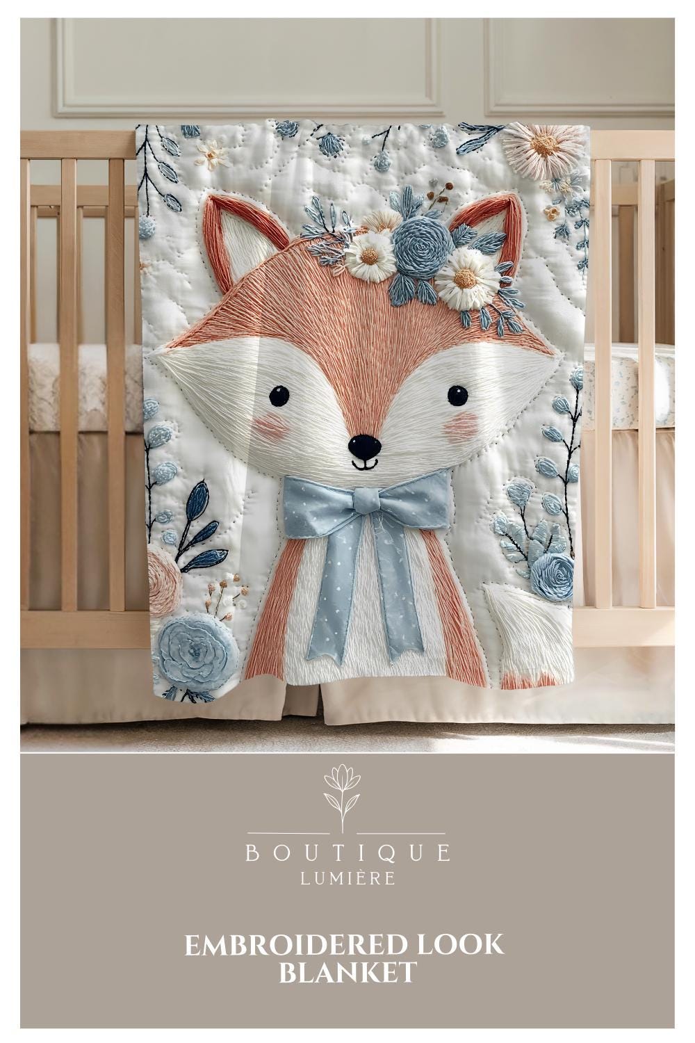Embroidered-look fox baby blanket with soft floral crown and gentle blue–peach stitched details on a neutral background.