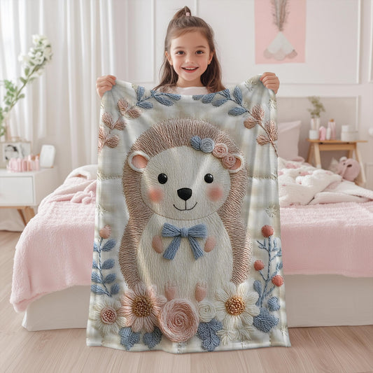 Hedgehog blanket with embroidered-look details in soft neutral colors. A cozy newborn blanket and timeless boutique baby gift.