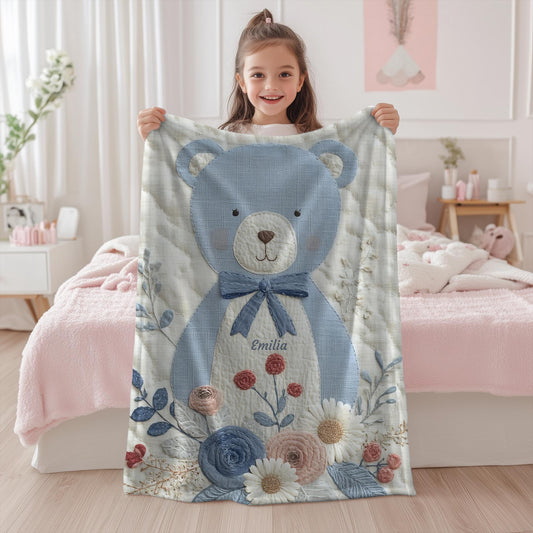 Personalized blue bear blanket with embroidered-look details in soft neutral colors. A cozy newborn blanket and timeless boutique baby gift.