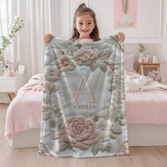 Personalized floral monogram baby blanket with elegant embroidered-look design. Soft, cozy fabric in calm neutral tones — a timeless nursery gift.