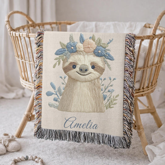 Woven cotton baby blanket with a calm sloth design. Personalized with name, neutral nursery decor and a timeless heirloom newborn gift.