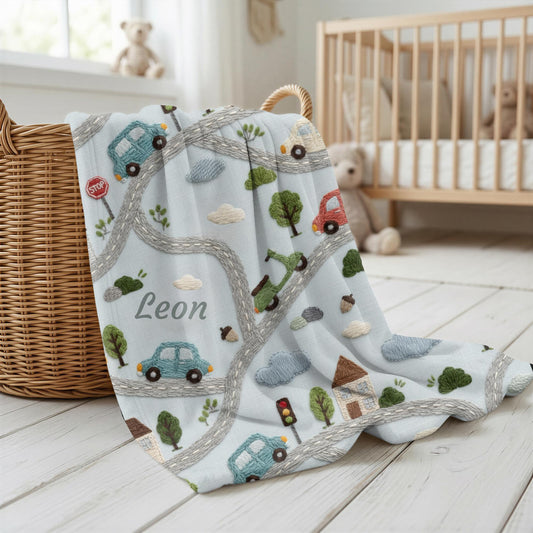 Personalized embroidered look baby blanket with stitched cars and winding streets. Soft vehicle themed nursery decor and unique baby gift.