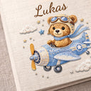Personalized teddy bear airplane baby memory book with name and birth date. A soft aviation nursery album for first memories and milestones.