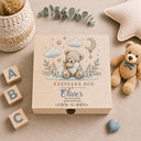 This magical large wooden keepsake box (30cm / 12 inch) is the perfect welcome for any new baby boy. A beautiful embroidered-style design printed directly onto the handcrafted wood features an adorable teddy bear resting on a cloud, surrounded by a crescent moon, twinkling stars, delicate botanical sprigs, and soft hearts — all in the most gentle, timeless palette of blue, cream, and gold.