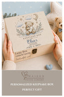 This magical large wooden keepsake box (30cm / 12 inch) is the perfect welcome for any new baby boy. A beautiful embroidered-style design printed directly onto the handcrafted wood features an adorable teddy bear resting on a cloud, surrounded by a crescent moon, twinkling stars, delicate botanical sprigs, and soft hearts — all in the most gentle, timeless palette of blue, cream, and gold.