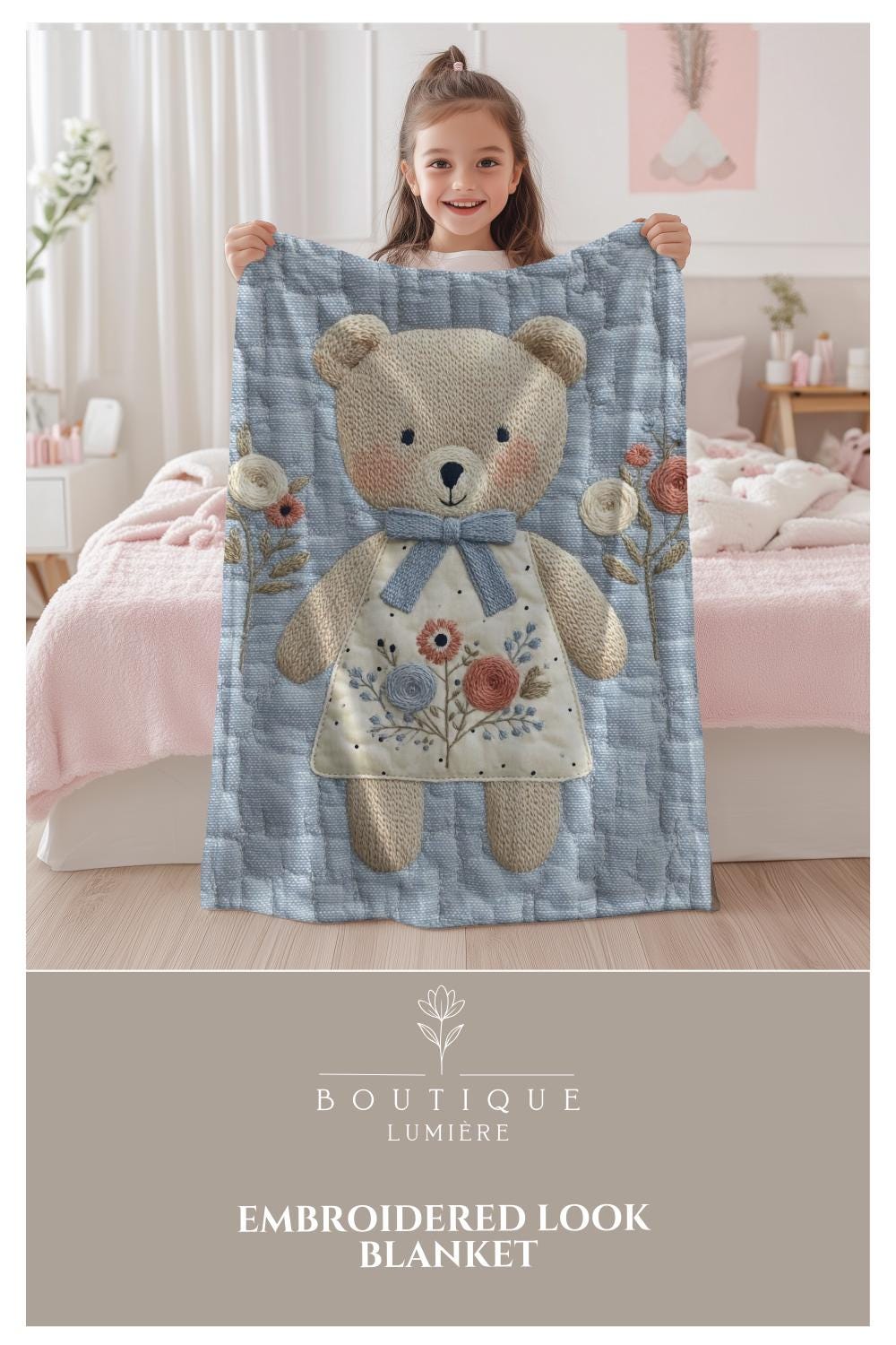 Embroidered-look teddy bear girl baby blanket with floral details on a soft blue quilted background.