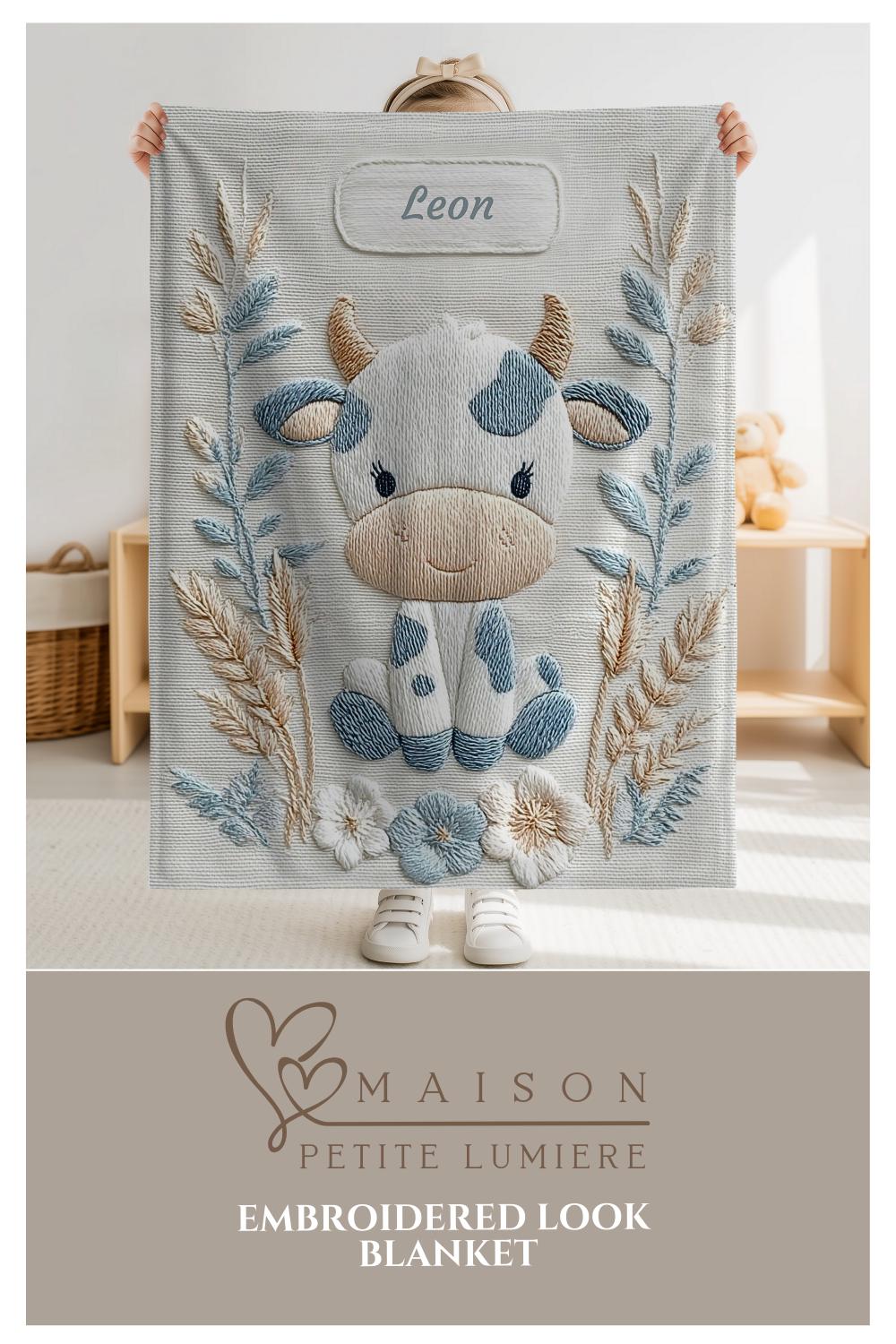 Cow embroidered-look baby blanket with pastel florals. Neutral tones, cozy fabric — a boutique newborn gift for calm, modern nursery decor.