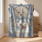 Embroidered-look teddy bear girl baby blanket with floral details on a soft blue quilted background.