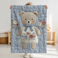 Embroidered-look teddy bear girl baby blanket with floral details on a soft blue quilted background.