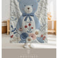 Personalized blue bear blanket with embroidered-look details in soft neutral colors. A cozy newborn blanket and timeless boutique baby gift.