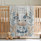 Cow embroidered-look baby blanket with pastel florals. Neutral tones, cozy fabric — a boutique newborn gift for calm, modern nursery decor.