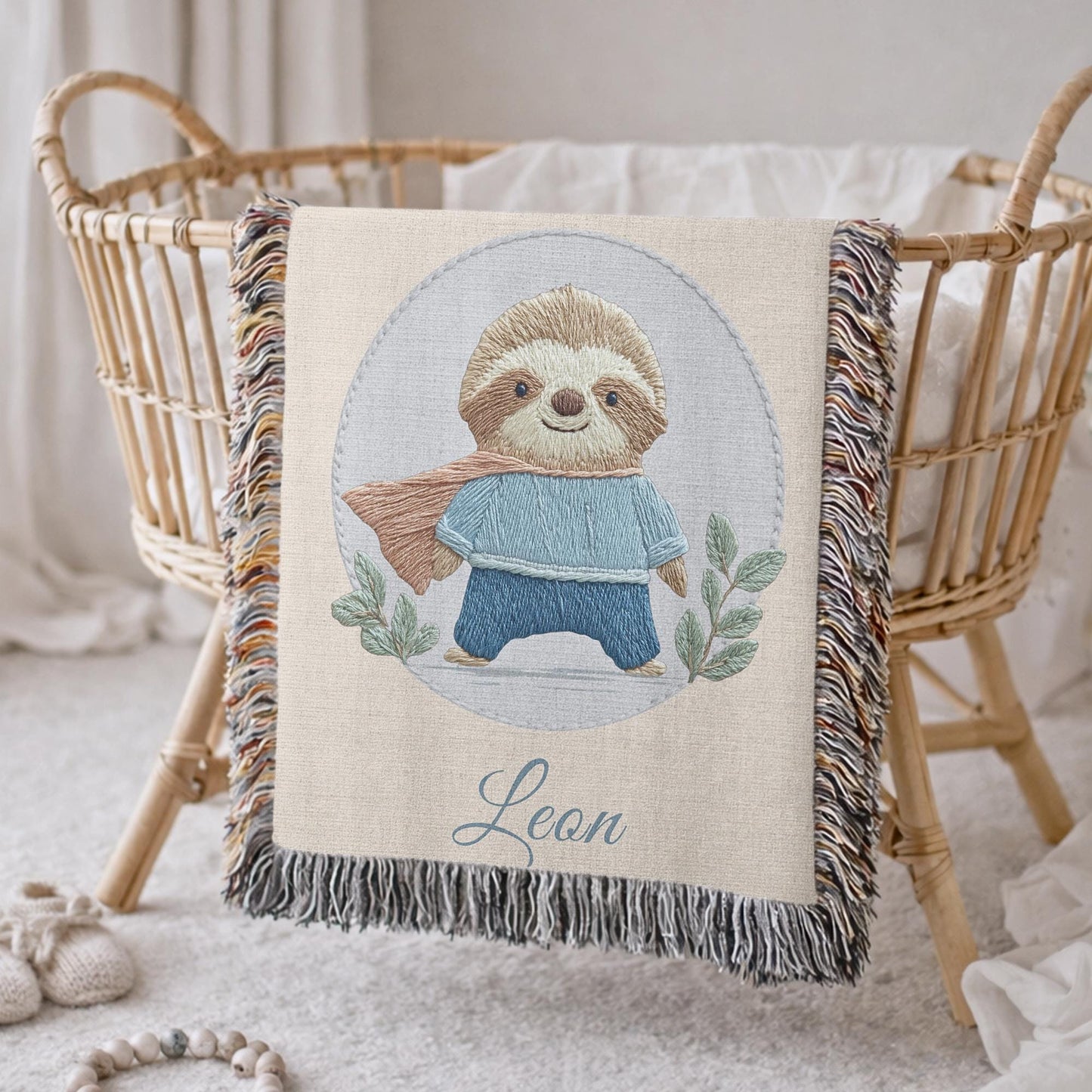 Personalized woven cotton baby blanket featuring a cute superhero sloth. Embroidered-look design, custom name, timeless nursery decor.