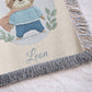 Personalized woven cotton baby blanket featuring a cute superhero sloth. Embroidered-look design, custom name, timeless nursery decor.