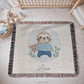 Personalized woven cotton baby blanket featuring a cute superhero sloth. Embroidered-look design, custom name, timeless nursery decor.