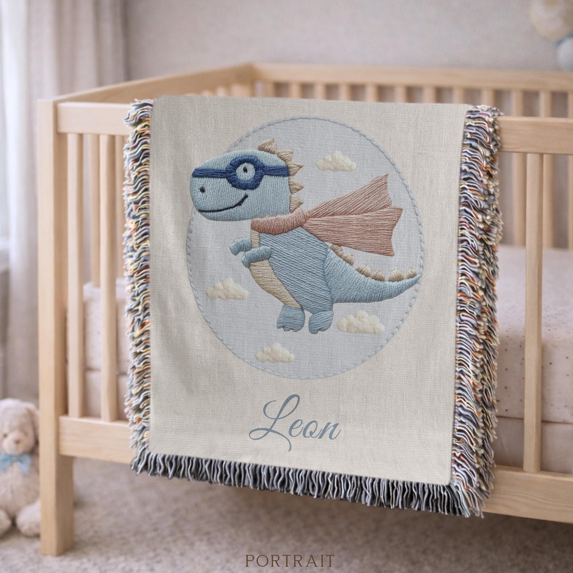 Personalized dinosaur woven baby blanket in 100% cotton. Embroidered-look superhero dino design, custom name keepsake for nursery decor.