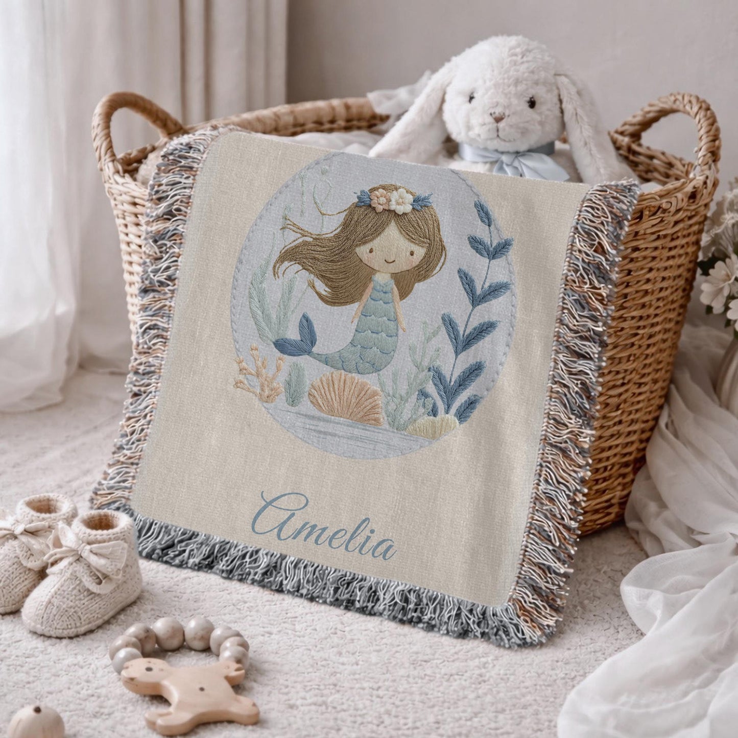 Personalized woven baby blanket featuring a calm mermaid design. Ocean under the sea nursery decor, crafted as a soft cotton tapestry keepsake.