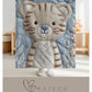 Soft embroidered-look baby blanket featuring a calm tiger motif with delicate floral details. Gentle neutral and pastel tones — a timeless boutique-style gift for modern, serene nurseries.