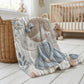 A soft embroidered-look baby blanket featuring a gentle angel fairy design in calm neutral tones. A timeless heirloom piece for modern nurseries, keepsakes and meaningful baby gifts.