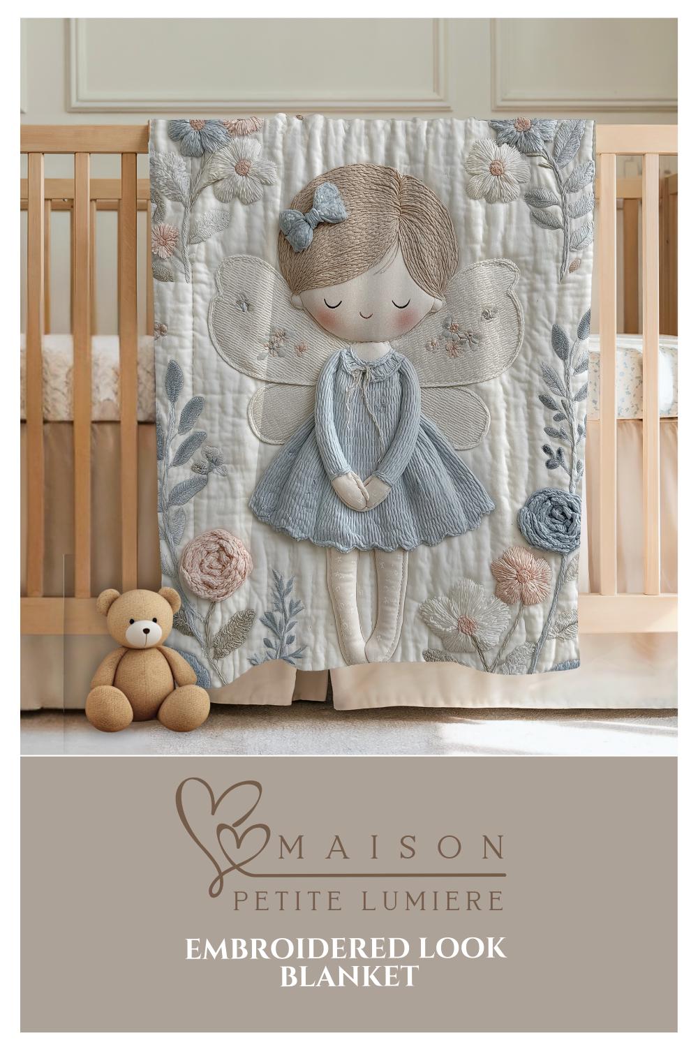 A soft embroidered-look baby blanket featuring a gentle angel fairy design in calm neutral tones. A timeless heirloom piece for modern nurseries, keepsakes and meaningful baby gifts.