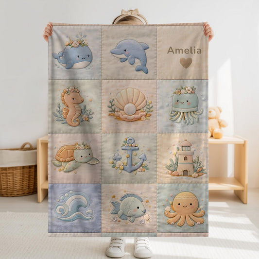 Personalized patchwork look baby blanket with name, whale, octopus and crab in a soft underwater quilt design. Cozy newborn blanket and baby gift.