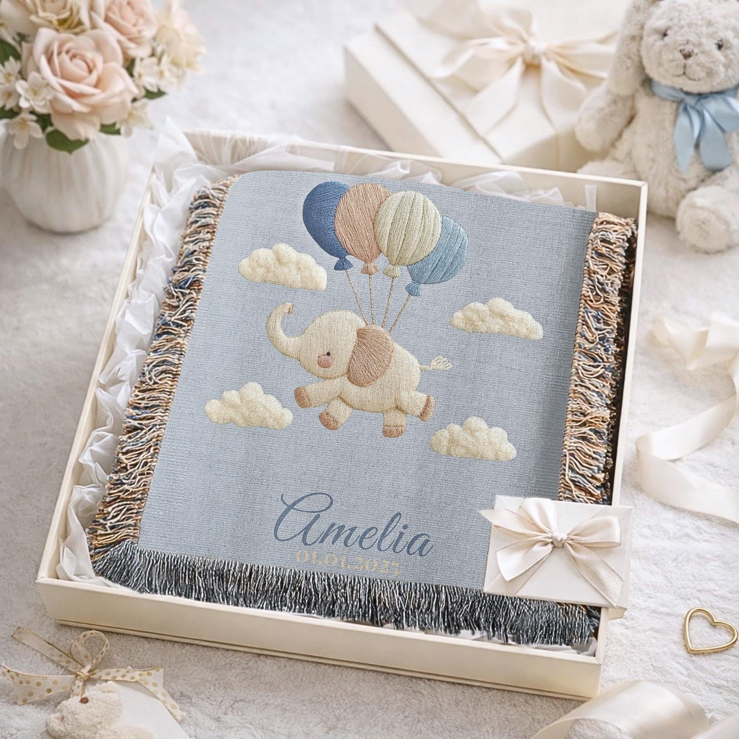 Personalized elephant woven blanket made from 100% cotton. A soft sky-themed nursery design featuring a baby elephant floating with balloons, woven in an embroidered-look finish — custom name and optional birth date included.