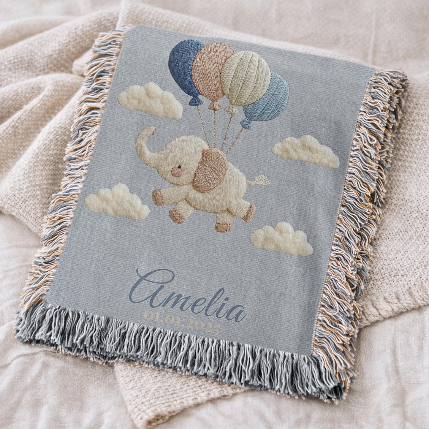 Personalized elephant woven blanket made from 100% cotton. A soft sky-themed nursery design featuring a baby elephant floating with balloons, woven in an embroidered-look finish — custom name and optional birth date included.