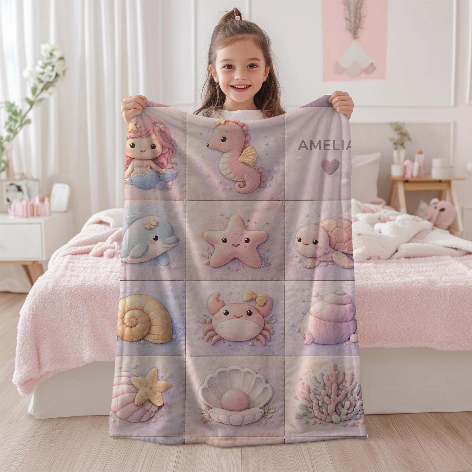 A personalized pink ocean baby quilt blanket with your baby’s name, designed in a soft patchwork look with gentle mermaid-inspired sea motifs.