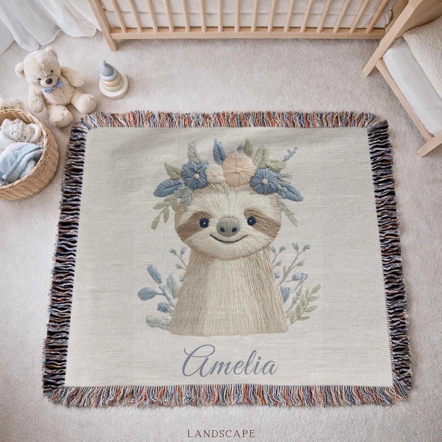 Woven cotton baby blanket with a calm sloth design. Personalized with name, neutral nursery decor and a timeless heirloom newborn gift.