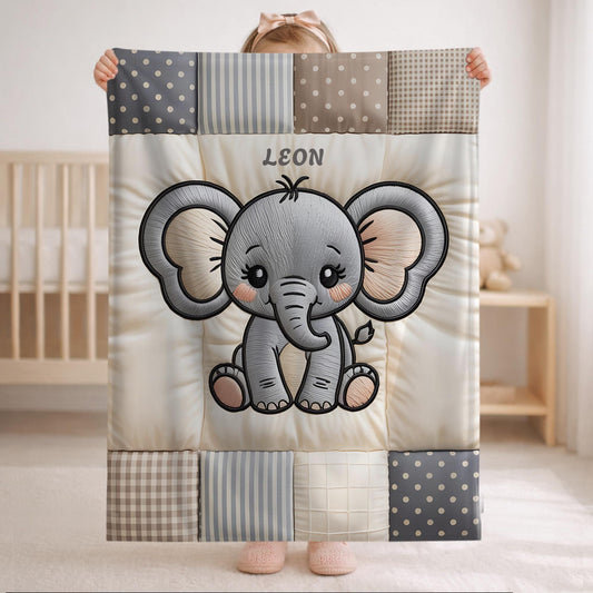 A personalized baby quilt blanket featuring a sweet elephant in an embroidered-look patchwork design. Soft neutral tones, perfect for nursery decor or a newborn gift.