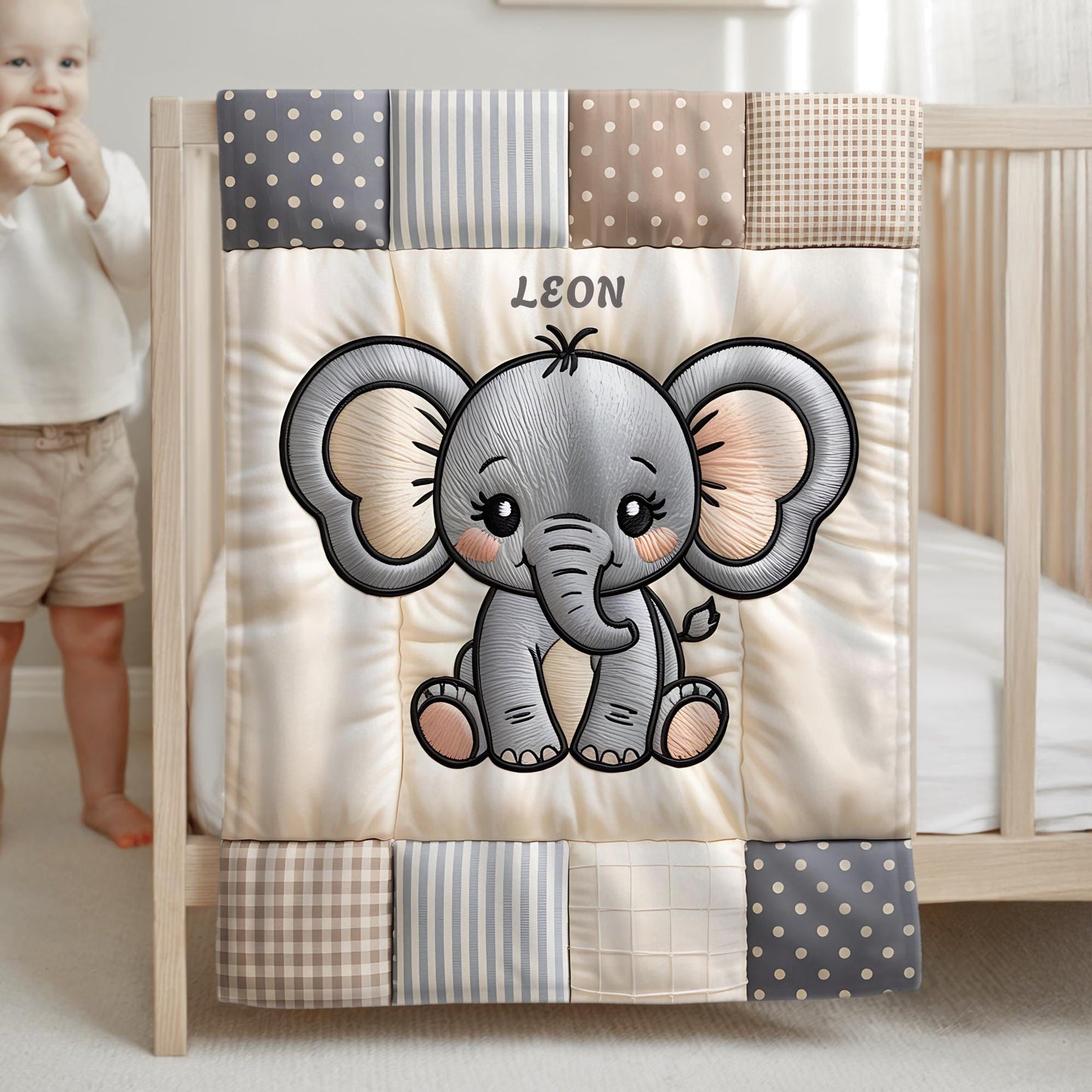 A personalized baby quilt blanket featuring a sweet elephant in an embroidered-look patchwork design. Soft neutral tones, perfect for nursery decor or a newborn gift.