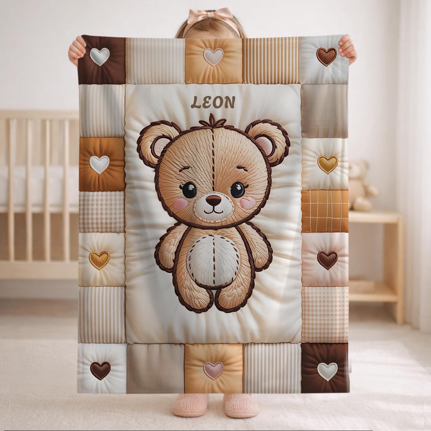 A personalized baby quilt blanket featuring a sweet teddy bear in an embroidered-look patchwork design. Soft neutral tones, perfect for nursery decor or a newborn gift.
