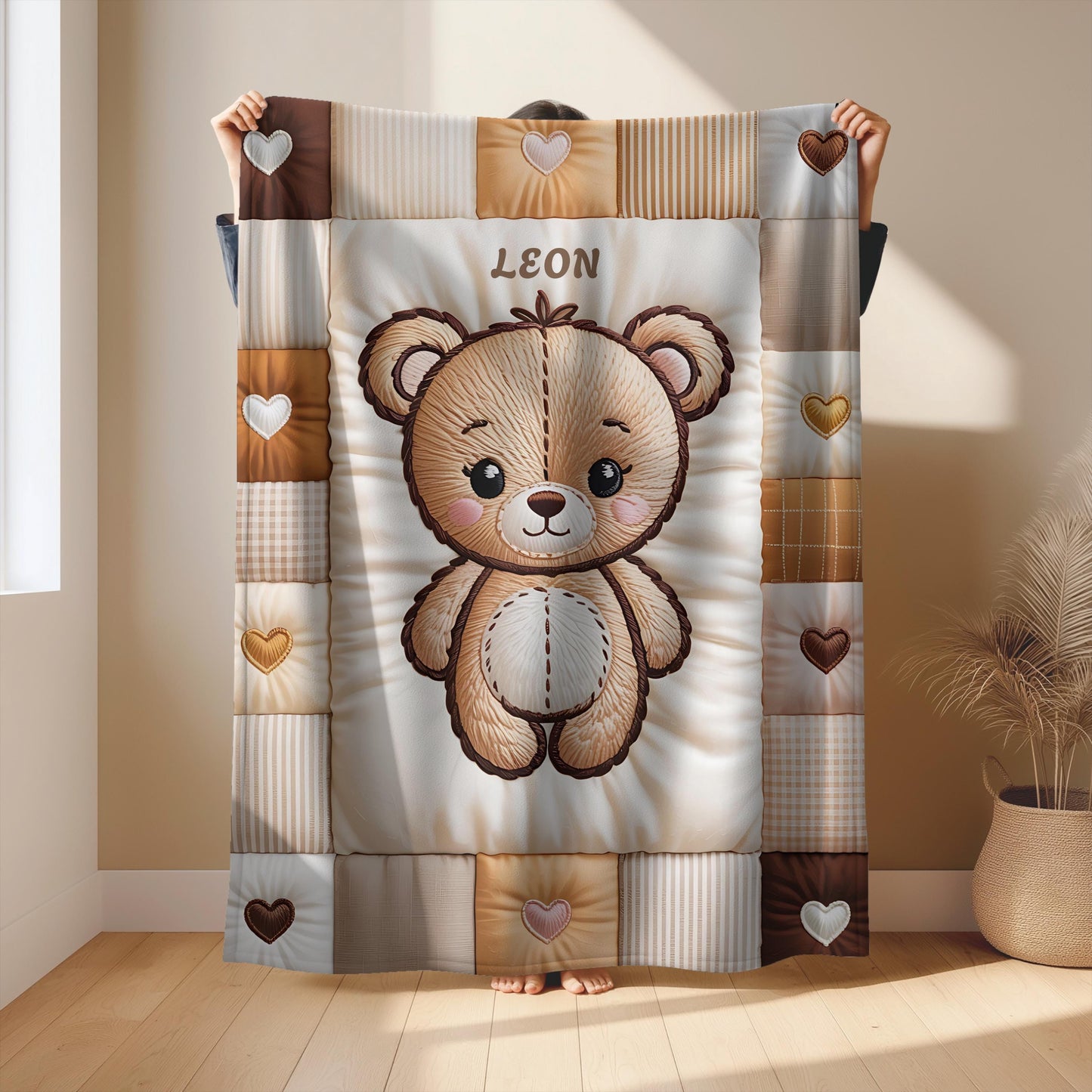A personalized baby quilt blanket featuring a sweet teddy bear in an embroidered-look patchwork design. Soft neutral tones, perfect for nursery decor or a newborn gift.