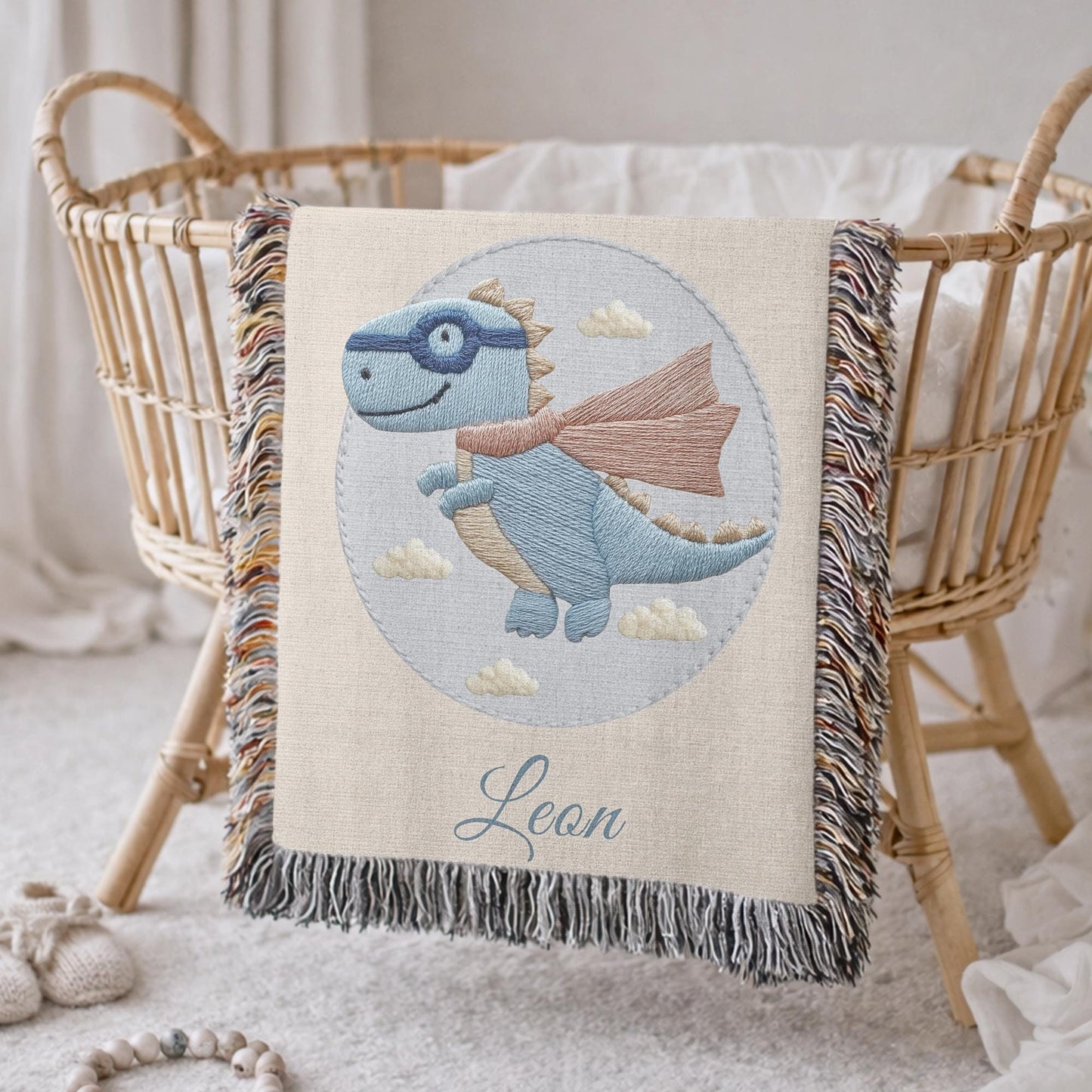 Personalized dinosaur woven baby blanket in 100% cotton. Embroidered-look superhero dino design, custom name keepsake for nursery decor.