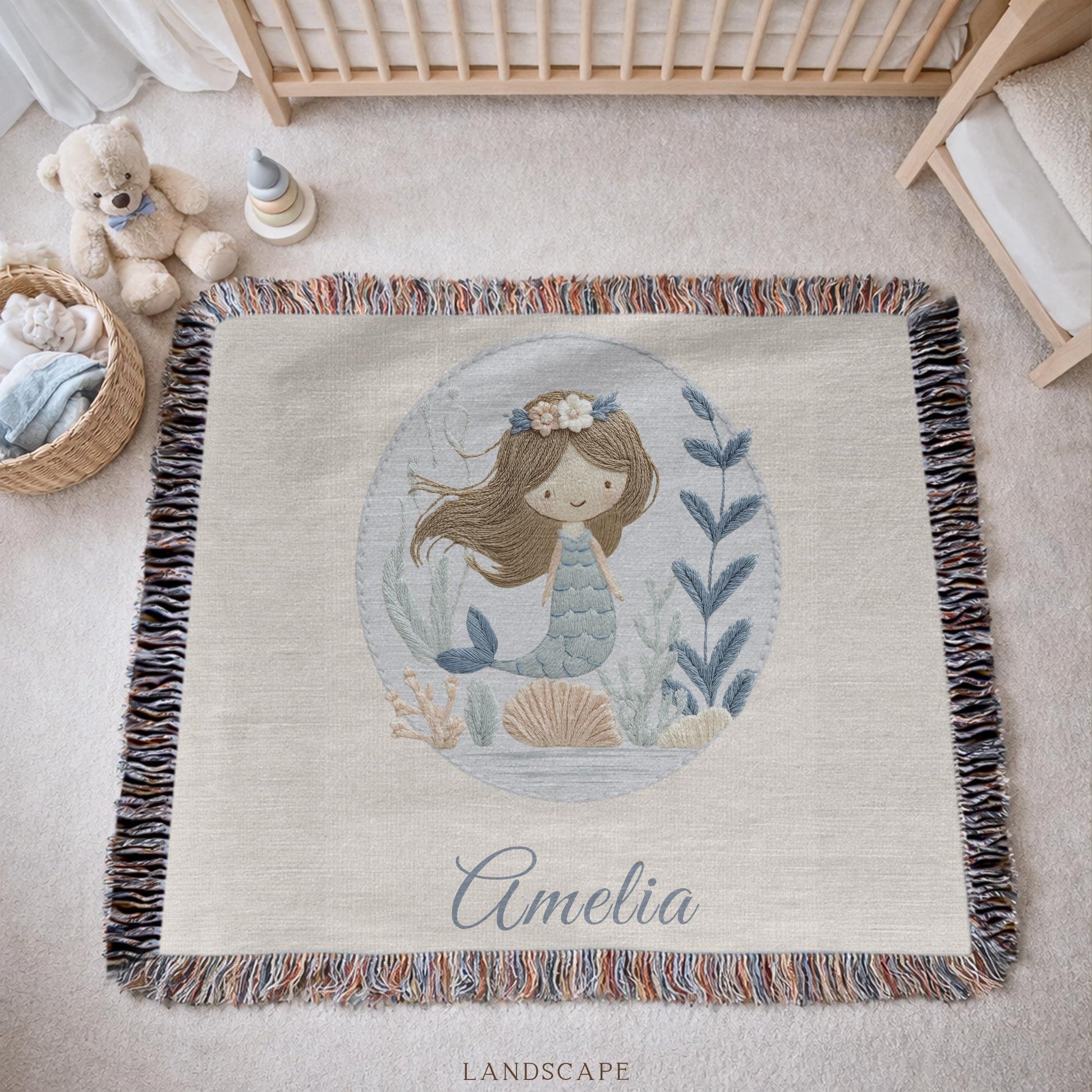 Personalized woven baby blanket featuring a calm mermaid design. Ocean under the sea nursery decor, crafted as a soft cotton tapestry keepsake.
