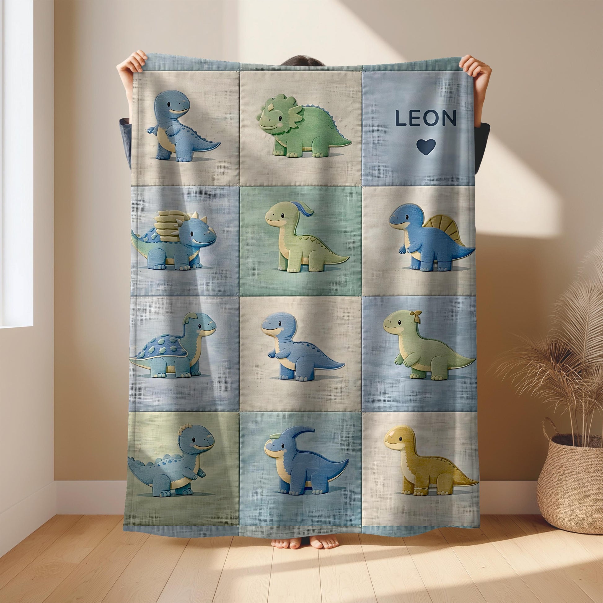 Personalized patchwork look baby blanket with cute dinosaurs in a soft quilt-style design. Neutral nursery colors with custom name panel.