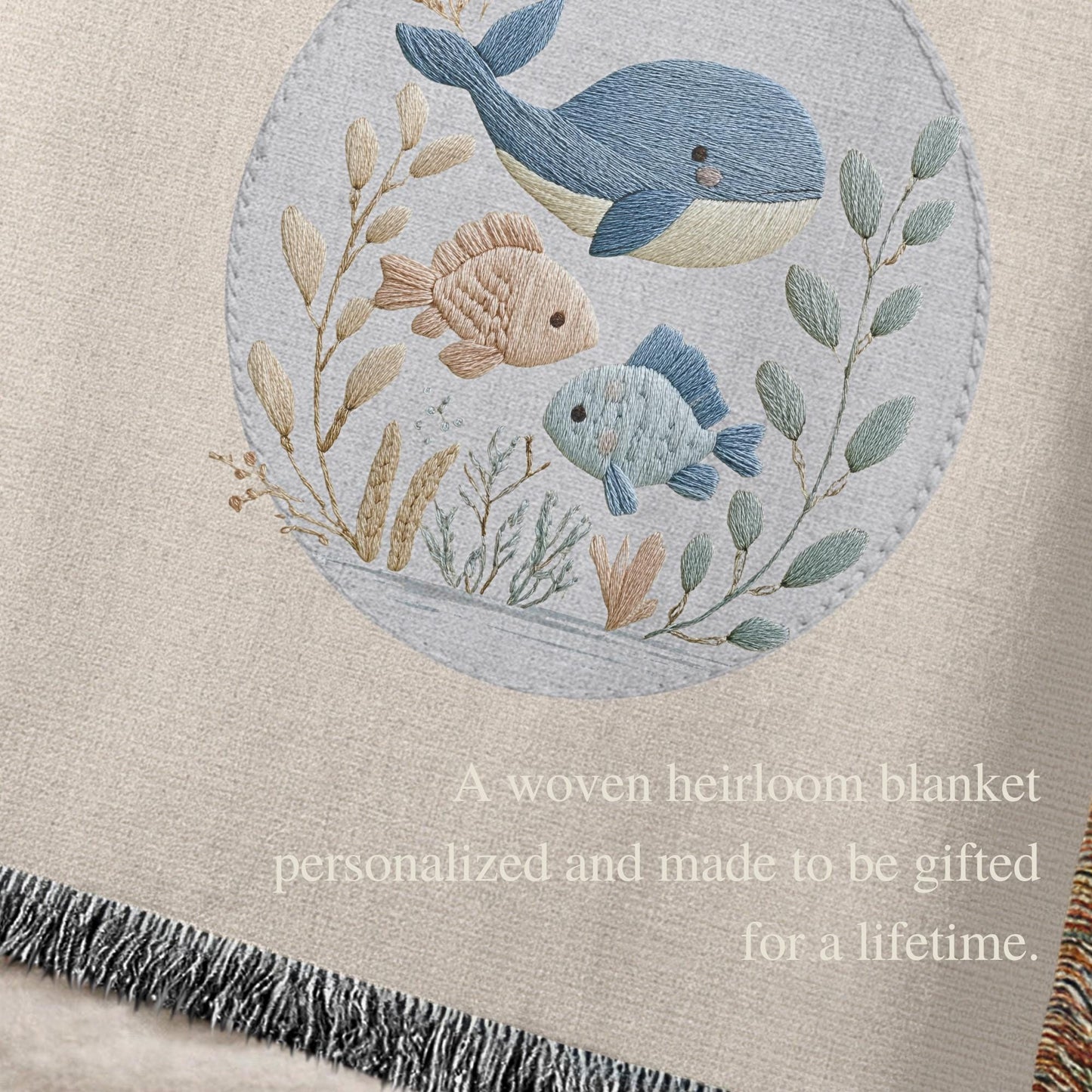 This personalized woven baby blanket features a gentle ocean theme with a sweet whale and fish design in a soft embroidered-look style.