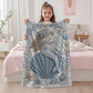 Soft embroidered-look mermaid baby blanket with a calm mermaid seashell design and pastel florals. Neutral tones, cozy fabric — a boutique newborn gift for serene, modern nursery decor.