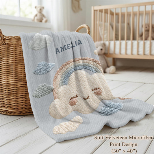 Personalized baby blanket with name in an embroidery look featuring a cloud with rainbow. Soft pastel tones – cozy velveteen or minky microfiber.