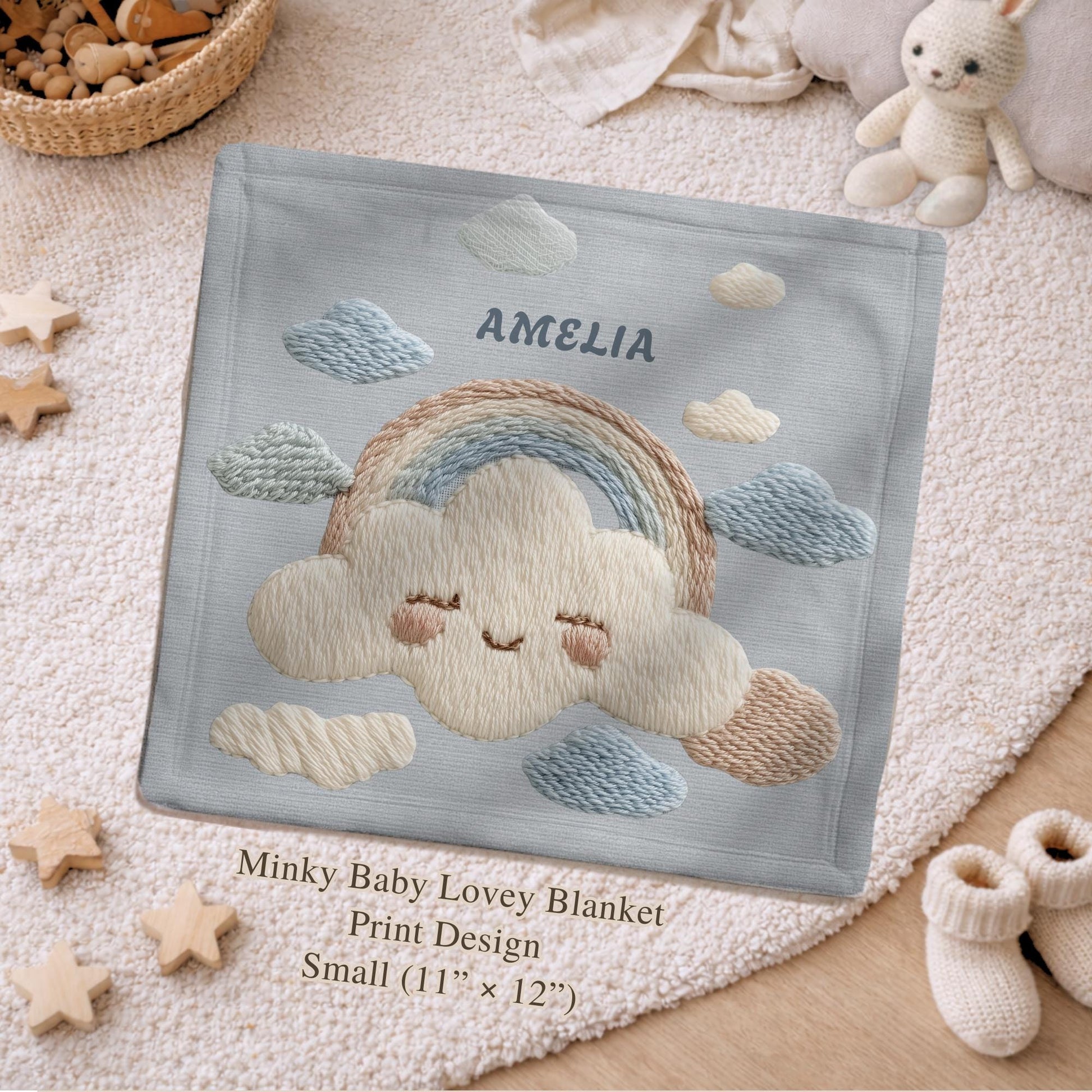 Personalized baby blanket with name in an embroidery look featuring a cloud with rainbow. Soft pastel tones – cozy velveteen or minky microfiber.