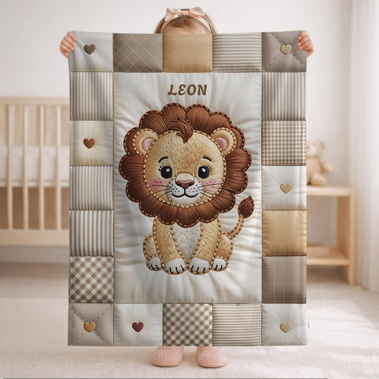 A personalized baby quilt blanket featuring a sweet lion in an heirloom-style patchwork look. Soft neutral tones – perfect for safari or neutral nurseries.