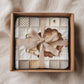 A personalized baby quilt blanket featuring a sweet lion in an heirloom-style patchwork look. Soft neutral tones – perfect for safari or neutral nurseries.
