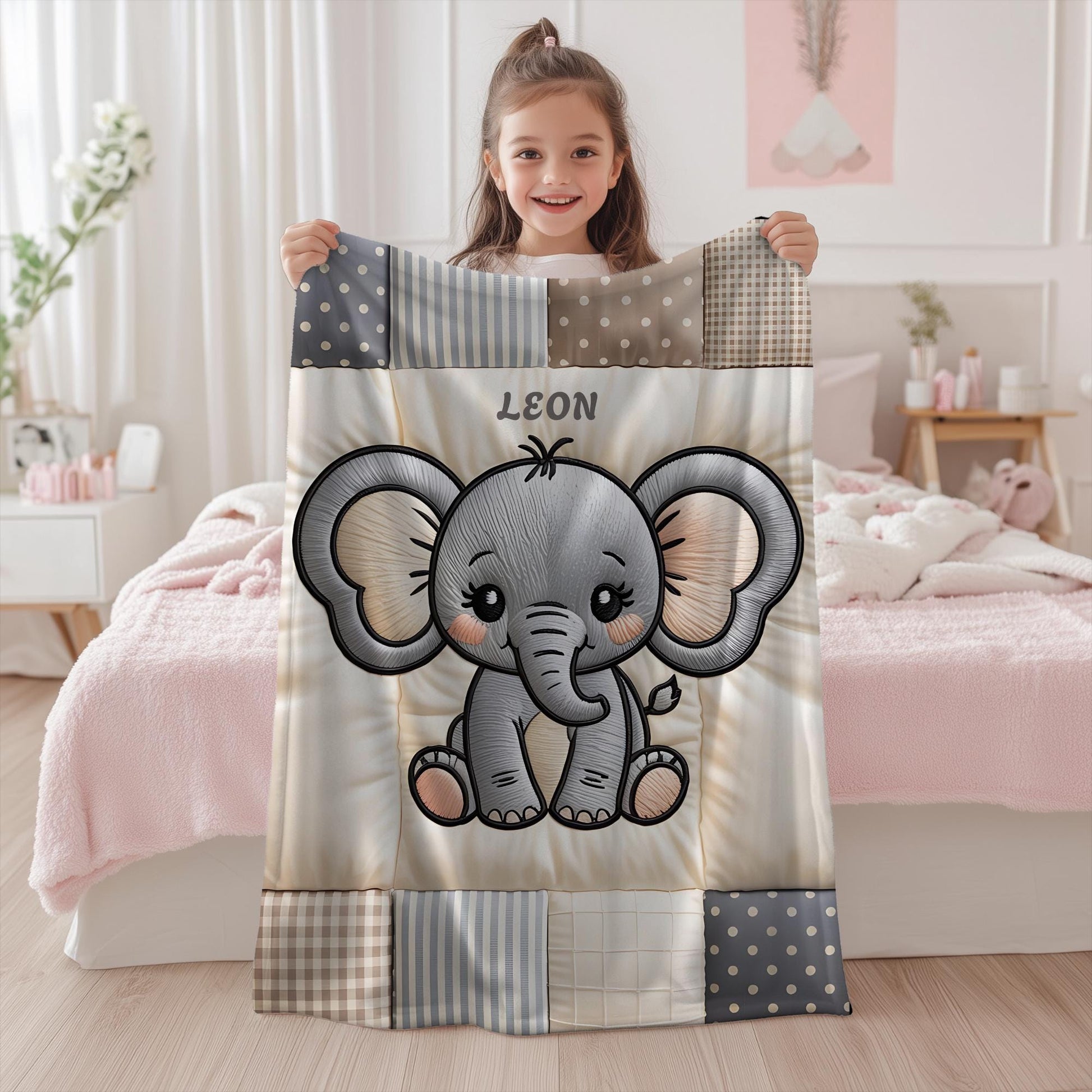A personalized baby quilt blanket featuring a sweet elephant in an embroidered-look patchwork design. Soft neutral tones, perfect for nursery decor or a newborn gift.
