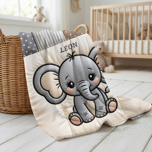 A personalized baby quilt blanket featuring a sweet elephant in an embroidered-look patchwork design. Soft neutral tones, perfect for nursery decor or a newborn gift.
