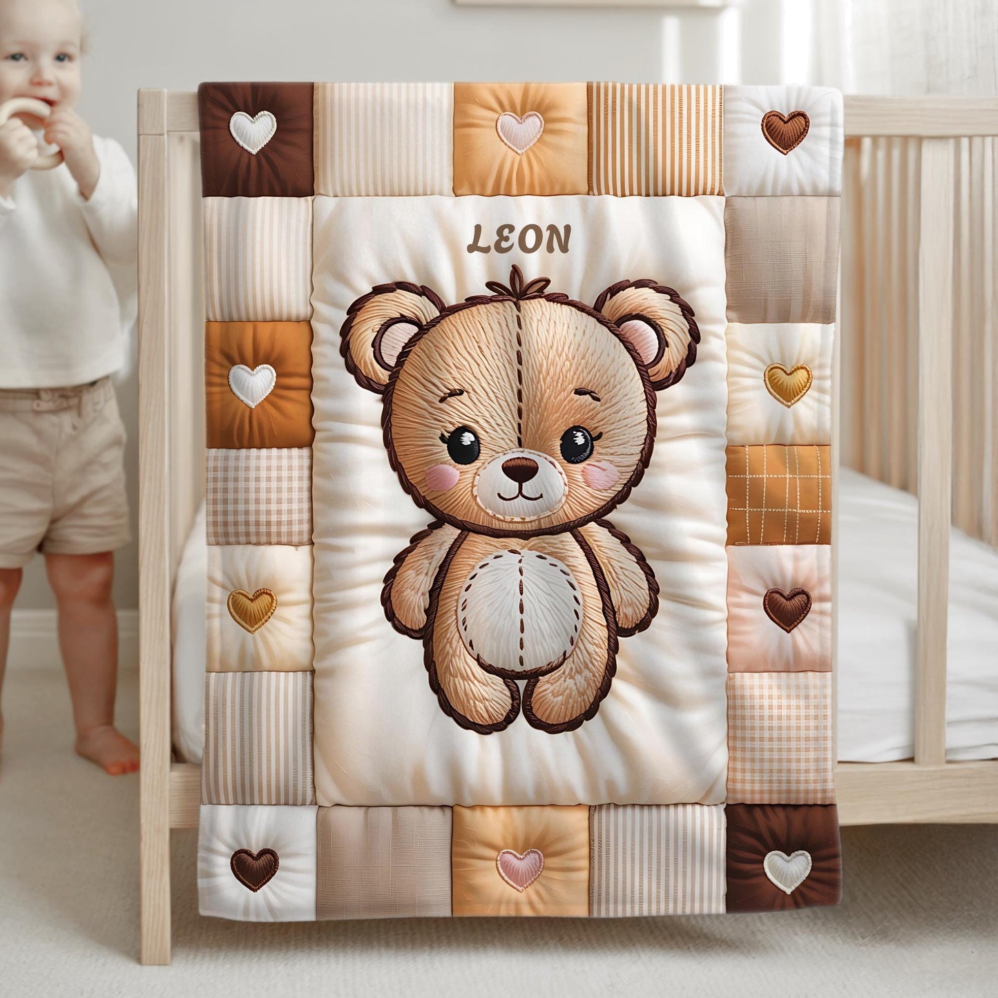 A personalized baby quilt blanket featuring a sweet teddy bear in an embroidered-look patchwork design. Soft neutral tones, perfect for nursery decor or a newborn gift.