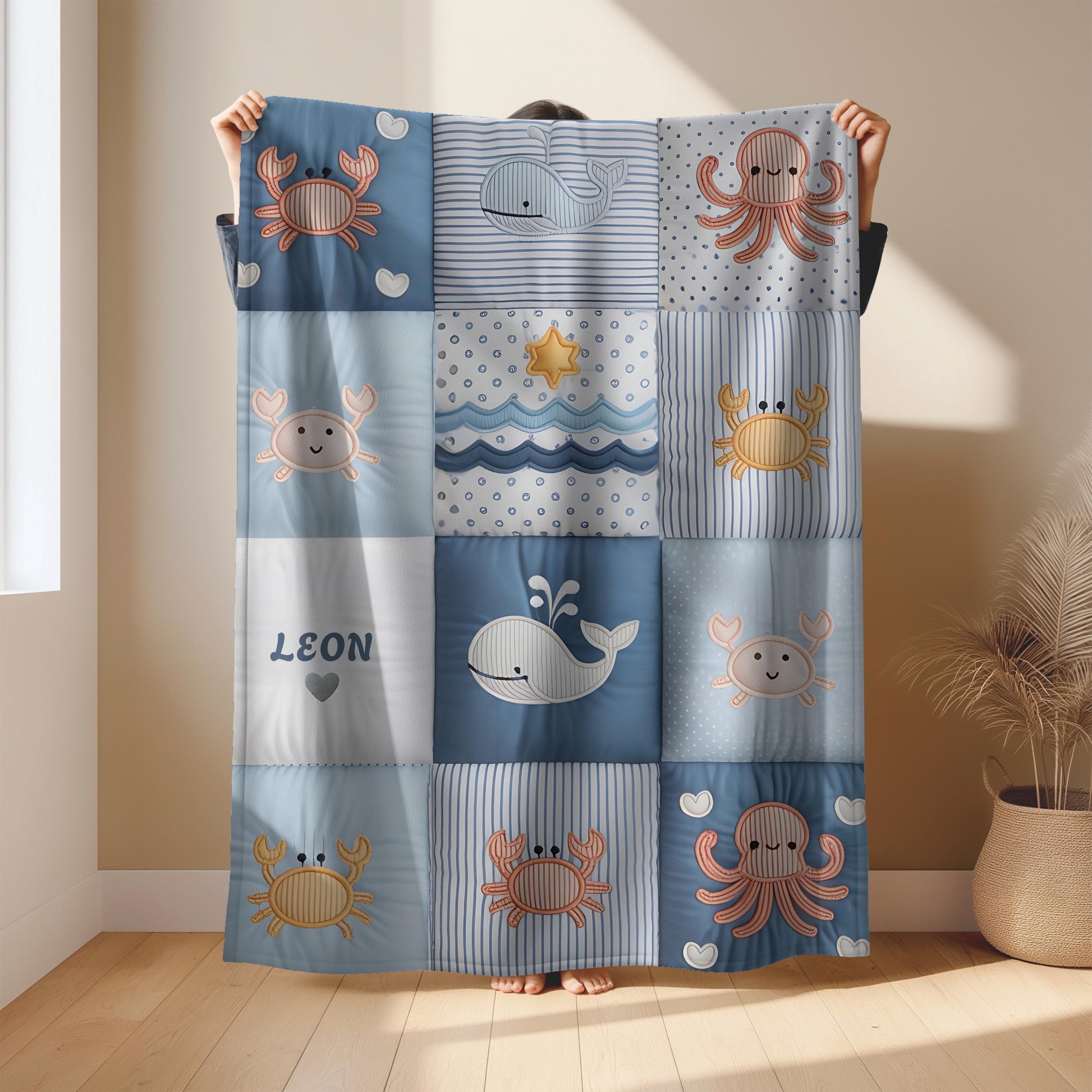 Personalized baby blanket with name in a patchwork look with whale and ocean motifs. Calm blue and beige tones – soft velveteen or minky.