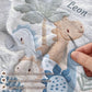 Personalized Dinosaur baby blanket with name - embroidered look details in soft neutral colors. A cozy newborn blanket and timeless boutique baby gift.
