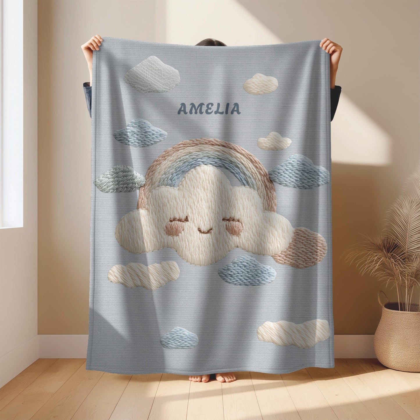 Personalized baby blanket with name in an embroidery look featuring a cloud with rainbow. Soft pastel tones – cozy velveteen or minky microfiber.