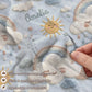 Personalized baby blanket in stitched look with dreamy clouds and rainbow. Soft neutral nursery decor and unique baby shower gift.
