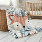 Embroidered-look fox baby blanket with soft floral crown and gentle blue–peach stitched details on a neutral background.