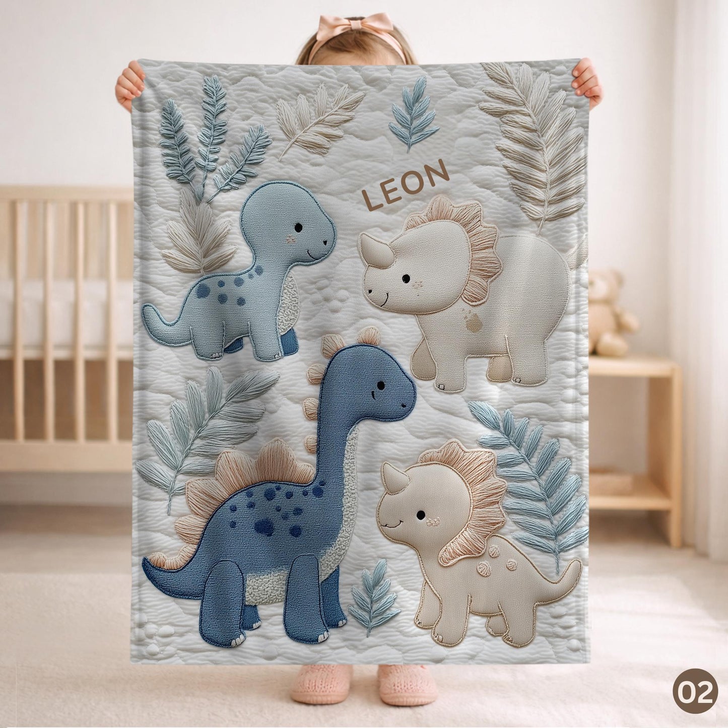 Personalized Dinosaur baby blanket with name - embroidered look details in soft neutral colors. A cozy newborn blanket and timeless boutique baby gift.